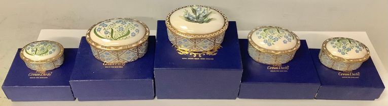 A set of five Royal Crown Derby Forget-me-not pattern graduated oval trinket dishes and covers,