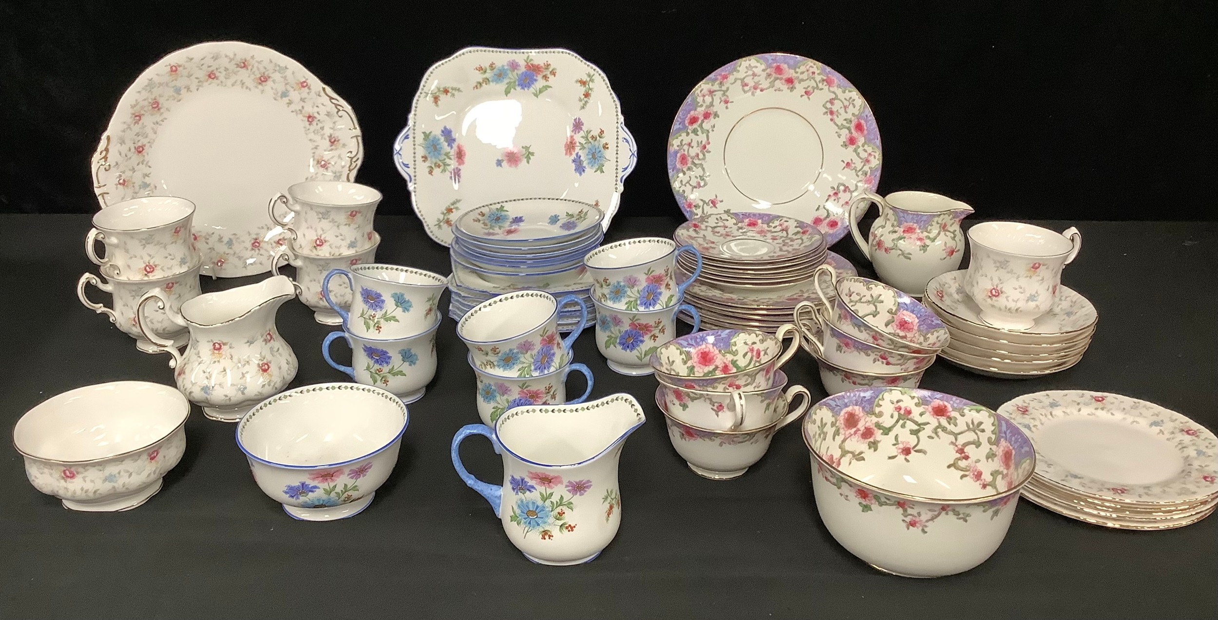 An Aynsley tea service for six, decorated with stylised pink and blue flowers, comprising cake