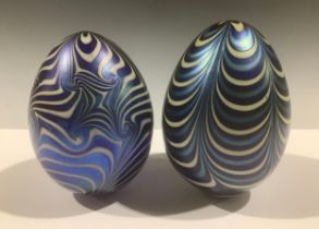 A matched pair of Vandermark opalescent glass eggs, in lustrous shades of blue and white, the