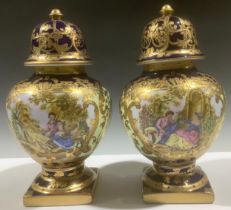 A pair of continental style pedestal baluster vases and covers, printed with courting couples in