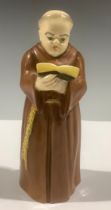 A Royal Worcester candle snuffer, Monk reading, 12cm, printed mark in black