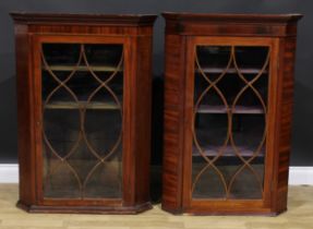 A near pair of 19th century mahogany corner display cabinets, the largest 113cm high, 75.5cm wide,