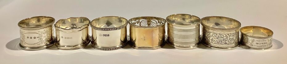 A Victorian silver napkin ring, Birmingham 1899; other silver napkin rings; 161g (7)
