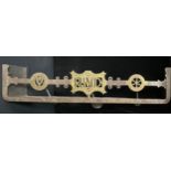An early 20th century steel and brass combination fire curb hearth trivet, the centre initialled