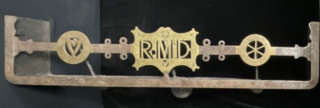 An early 20th century steel and brass combination fire curb hearth trivet, the centre initialled