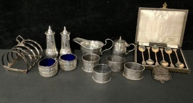 A pair of Edwardian silver pepper pots, domed pierced covers, slender baluster form, each applied