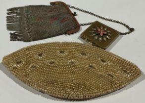 A pearl evening bag; a mesh evening bag; a compact