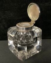 An inkwell with hallmarked silver top