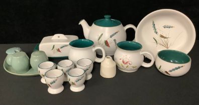 A Denby Greenwheat pattern teapot, butter dish, serving bowl, five eggcups, sugar bowl, two