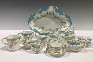 A Royal Crown Derby miniature tea service, decorated with floral and gilt swags beneath a pale