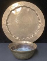 A Chinese brass bowl, engraved with dragons and ships, 25cm diameter; a Persian style circular tray,