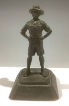 A patinated bronze figure, of a Boy Scout, oak base, 13cm high
