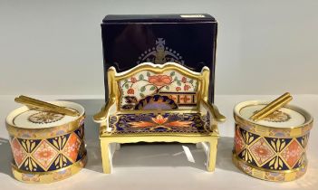 A Royal Crown Derby Pardoe pattern miniature Garden Bench, 8.5cm wide, boxed, each with red Royal