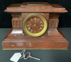 A French architectural rouge marble mantel clock, gilded Roman numerals, twin winding holes, 33cm
