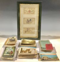 A collection of postcards and framed WWI silks