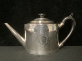 A George III silver oval teapot, angular spout, ebonised scroll handle and knop, pair of vacant