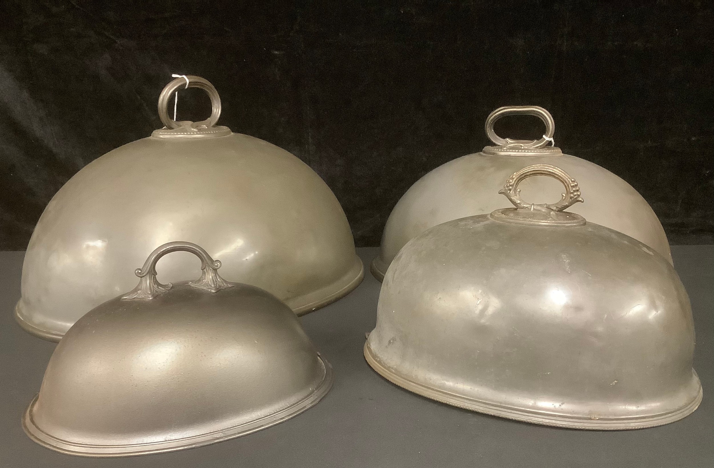 A set of three late 19th century pewter graduated meat domes, scroll handles, James Dixon & Sons,
