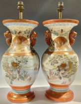 A pair of Japanese Kutani two-handled vases, decorated with courtyard scene and fanciful birds,