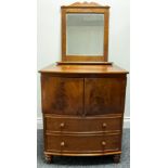 A Victorian mahogany bow front night chest, the top lifting above a pair of flame veneered drawers