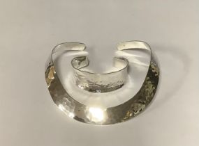 A silver planished torque choker, marked 925; a similar bangle, marked 925; 92g (2)