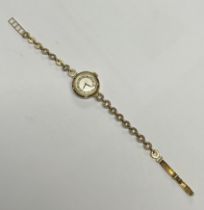 A lady's 9ct gold watch, silvered dial, Arabic numerals, the case marked 375, integral 9ct gold