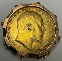 An Edward VII gold full sovereign, 1910, metal mounted as a pendant/brooch, 10.4g gross