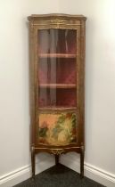 A Louis XV style gilt metal mounted mahogany serpentine corner vitrine, three-quarter glazed door