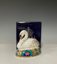 A Royal Crown Derby Paperweight, White Swan Nesting, gold stopper, 14cm long, printed mark, boxed