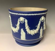 A large Wedgwood Jasperware jardinière, typically sprigged in white on a cobalt blue ground, applied