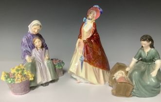 A Royal Doulton figure group, Cradle Song, HN2246; another, Granny's Heritage, HN2031; a Royal