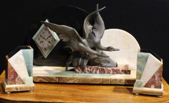 A large Art Deco design marble and onyx mantel clock garniture, modelled as a pair of geese flying