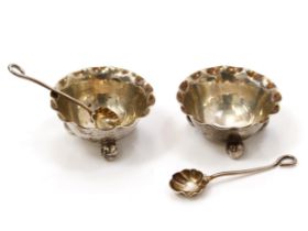 A pair of EPNS table salts and spoons, pinched rims, ball feet (2)