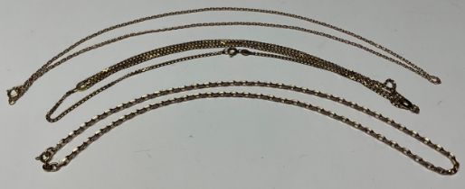 A 9ct rose gold necklace chain, marked 375, 9.4g; two other 9ct gold necklaces, marked 375, 11.9g