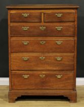 A George II oak chest, of unusual proportions, rectangular top above two short and four long