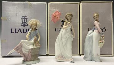 A Lladro figure, Picture Perfect, 7612, 21cm, printed and impressed marks, boxed; two others,