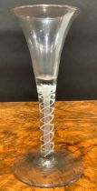 A George III opaque twist drinking glass, trumpet shaped bowl, double helix stem, domed circular