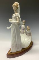 A Lladro figure group, Here Comes The Bride, 1446, designed by Jose Puche, 35cm, oval plinth base,