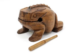 A carved hardwood frog rasp percussion instrument, 26cm long