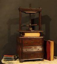 An 18th century Dutch oak bombe shaped table top book press, the lower section as a miniature