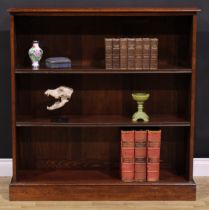 An early 20th century mahogany open bookcase, oversailing top above two adjustable shelves, plinth