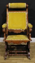 An unusual 19th century American walnut rocking chair, adjustable headrest, shaped arms, reeded