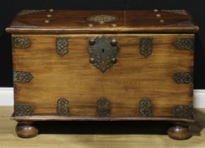 A Zanzibar hardwood chest, typically brass mounted, hinged cover enclosing a till, carrying