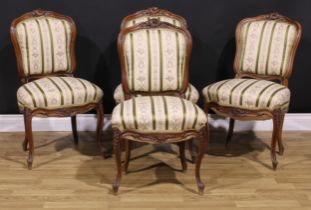 A set of four late 19th century French Louis XV Revival dining chairs, stuffed-over upholstery,
