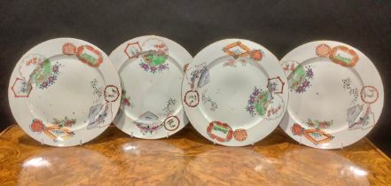A set of four Chinese circular plates, decorated in polychrome enamels, with reserves of Mandarin