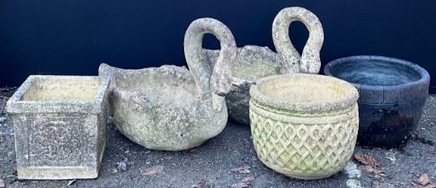 A pair of reconstituted stone garden planters, as swans, 55.5cm high, 67cm long, 40cm wide;