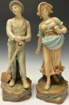 A pair of Continental porcelain figures, Farm Girl and Boy, after Schoop, 35cm high