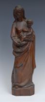 A Continental softwood ecclesiastical carving, Madonna and Child, canted rectangular base, 41cm