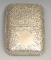 An Edwardian silver rounded rectangular twin-cover cigar case, profusely engraved with scrolling