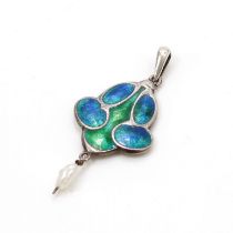 An unmarked white metal and enamel pendant, decorated in the 'Art Nouveau' taste and Charles