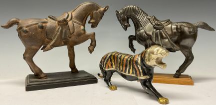 A 20th century dark patinated bronze, Tang type horse, fore leg raised, rectangular chamfered
